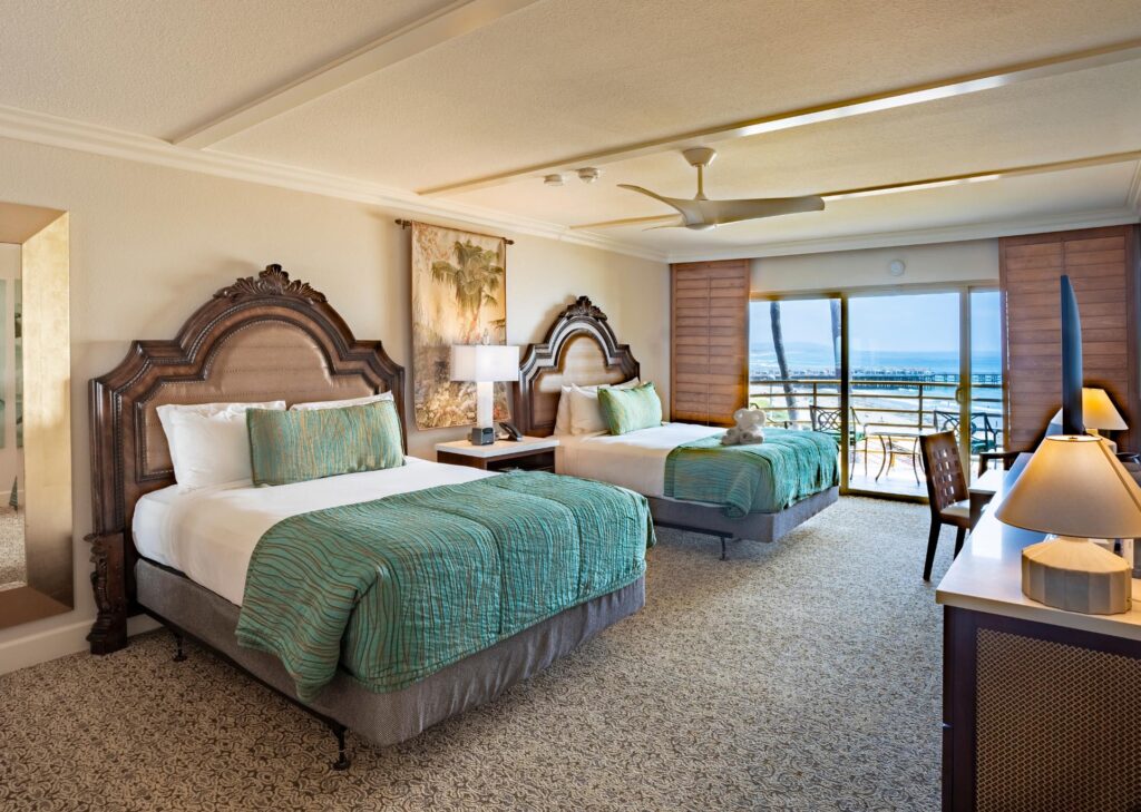 Ocean View Room with two beds, fan, and patio