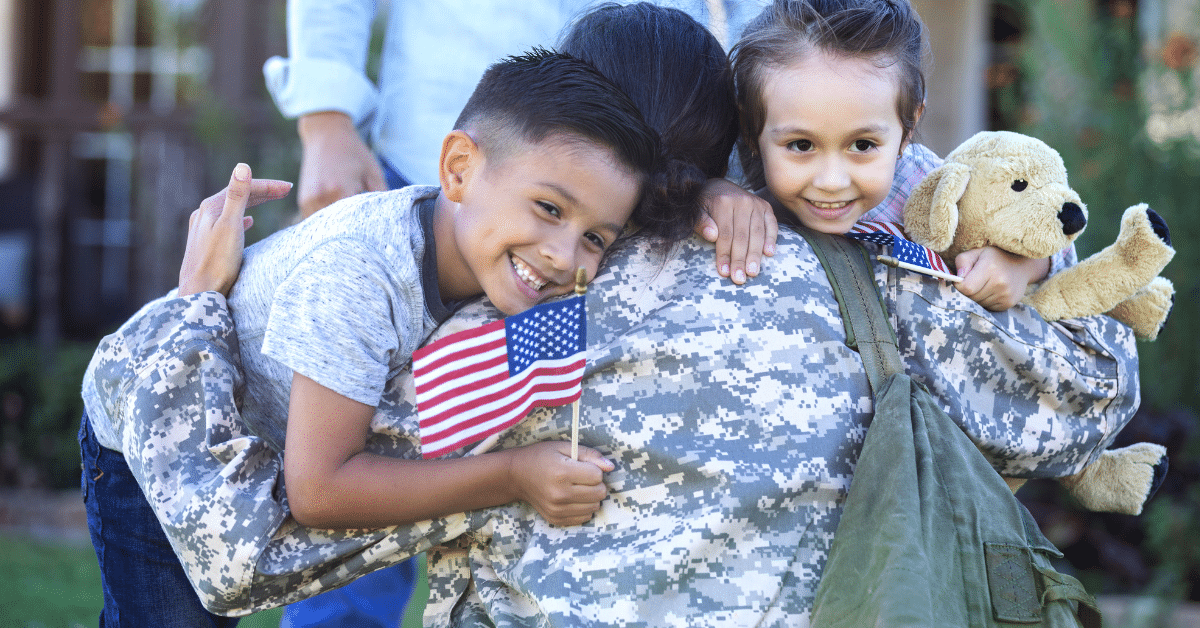 Kids hugging their military mom landscape